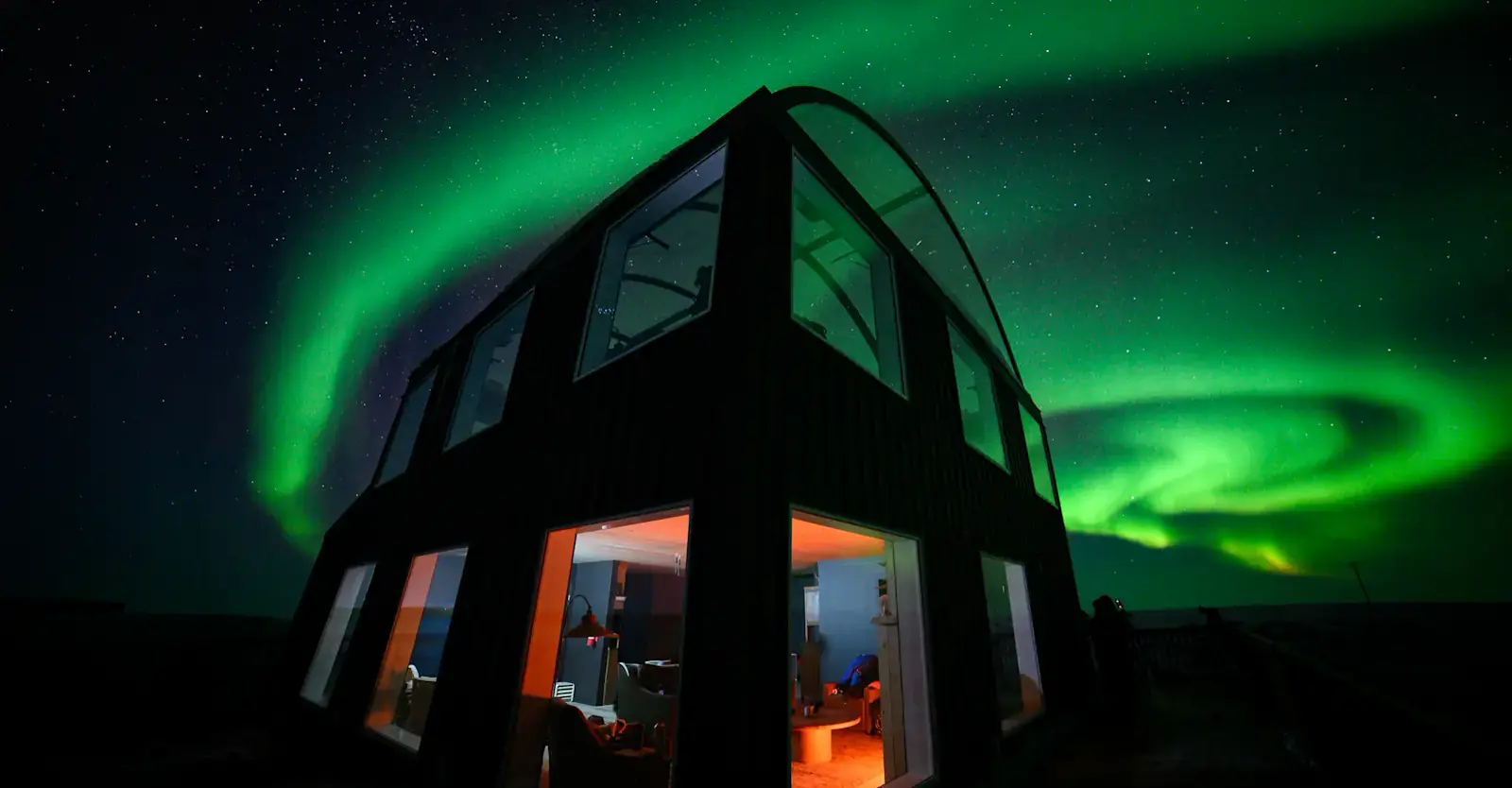 Northern lights over a boreal forest lodge near Churchill, Manitoba