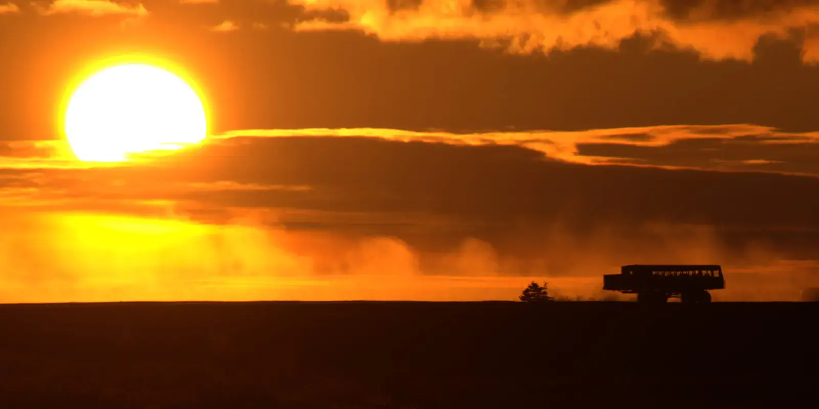 Silhouette of a Polar Rover crossing the tundra at sunset