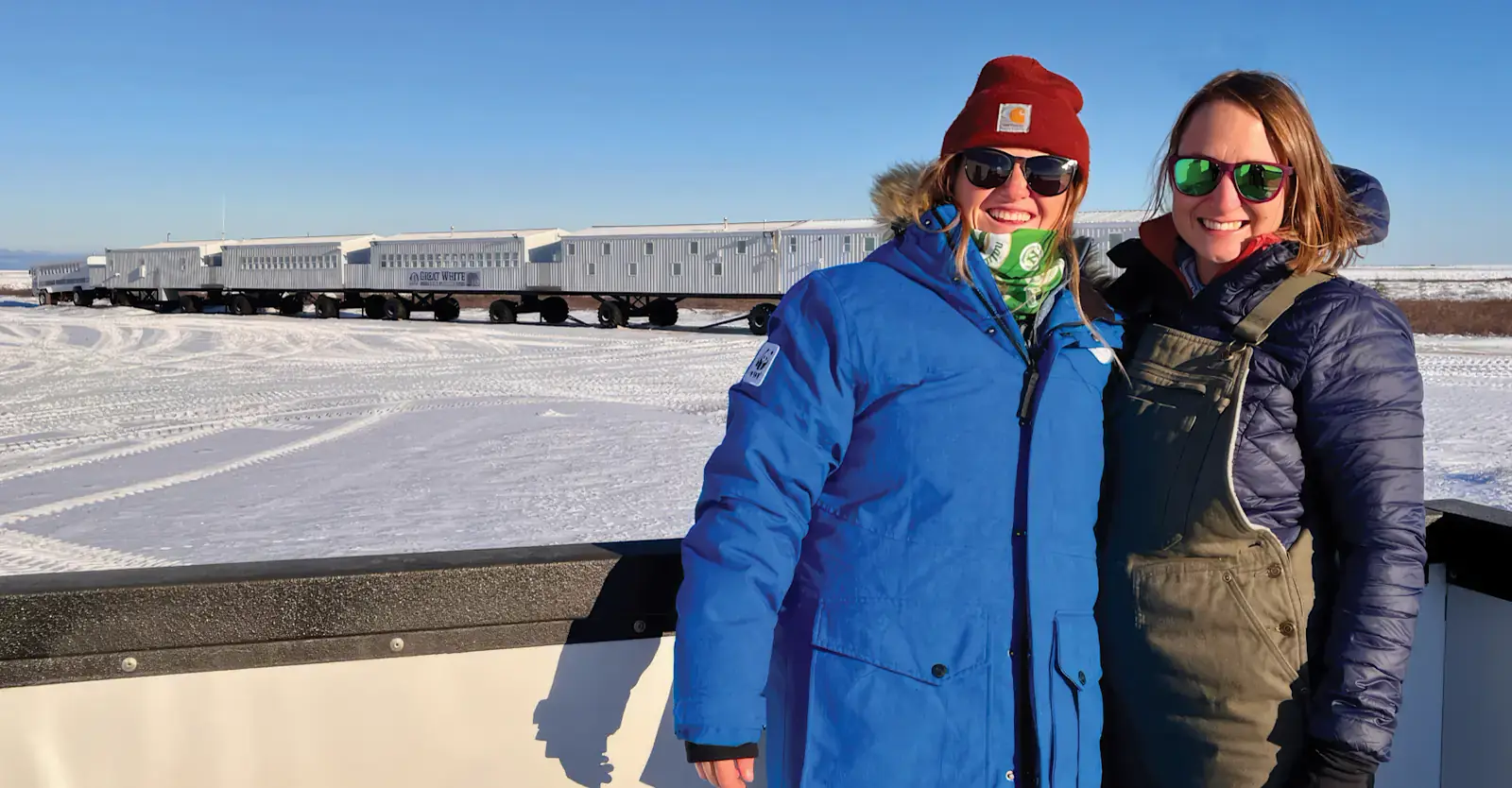 Travelers outside the Tundra Lodge on a clear winter day, Churchill